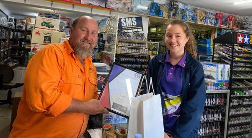  Customer receiving a plaque of Appreciation at Scale Auto’s Hobbies & Collectibles